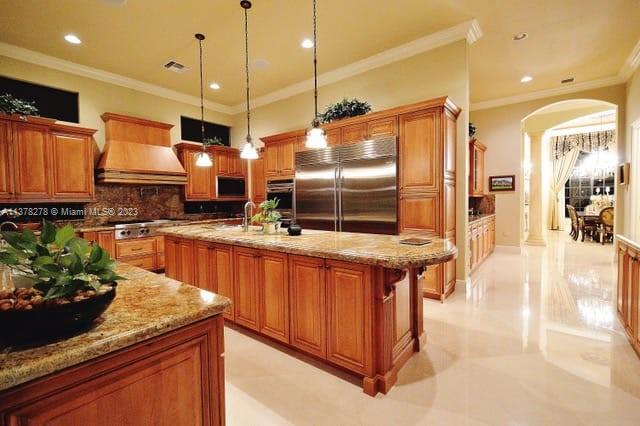 19349 Waters Edge Street Weston, FL 33332 - Photo 4 of 63 a kitchen with stainless steel appliances kitchen island granite countertop a stove a sink and a microwave