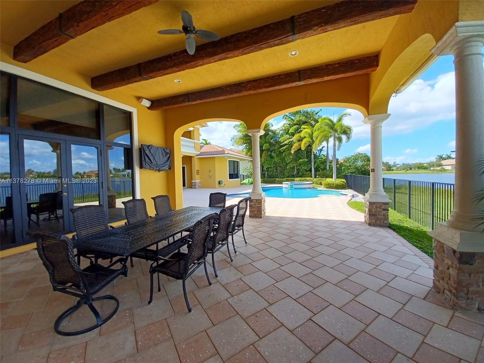 19349 Waters Edge Street Weston, FL 33332 - Photo 43 of 63 a view of a patio with a table and chairs