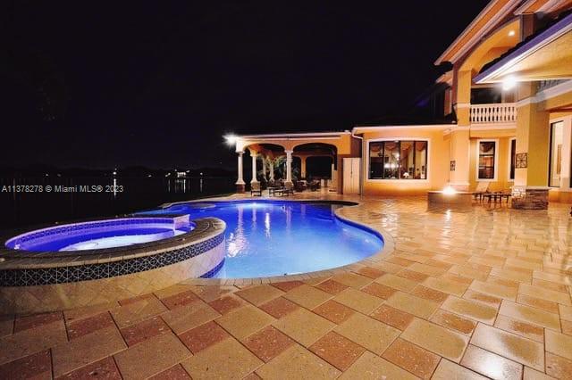 19349 Waters Edge Street Weston, FL 33332 - Photo 45 of 63 a view of a swimming pool with an outdoor space and seating area