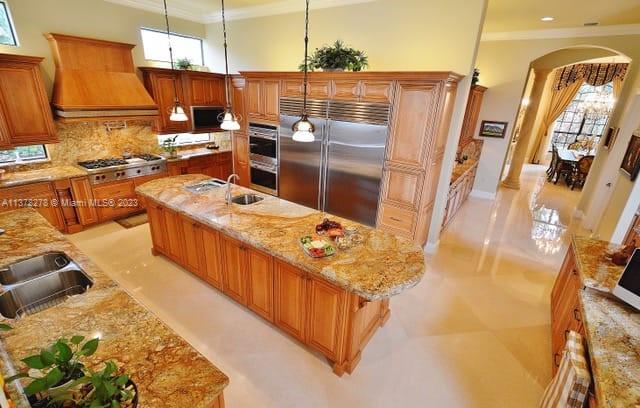 19349 Waters Edge Street Weston, FL 33332 - Photo 5 of 63 a kitchen with stainless steel appliances granite countertop a stove a sink and a refrigerator