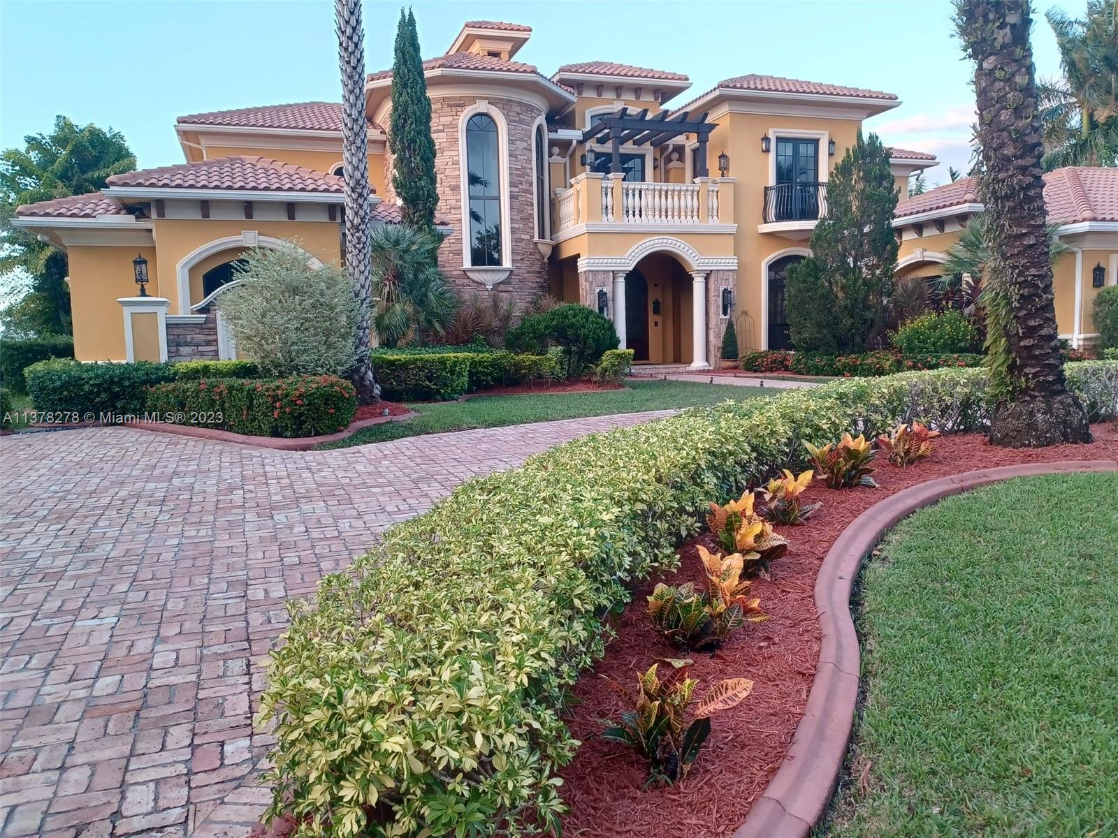 19349 Waters Edge Street Weston, FL 33332 - Photo 63 of 63 a front view of a house with a garden
