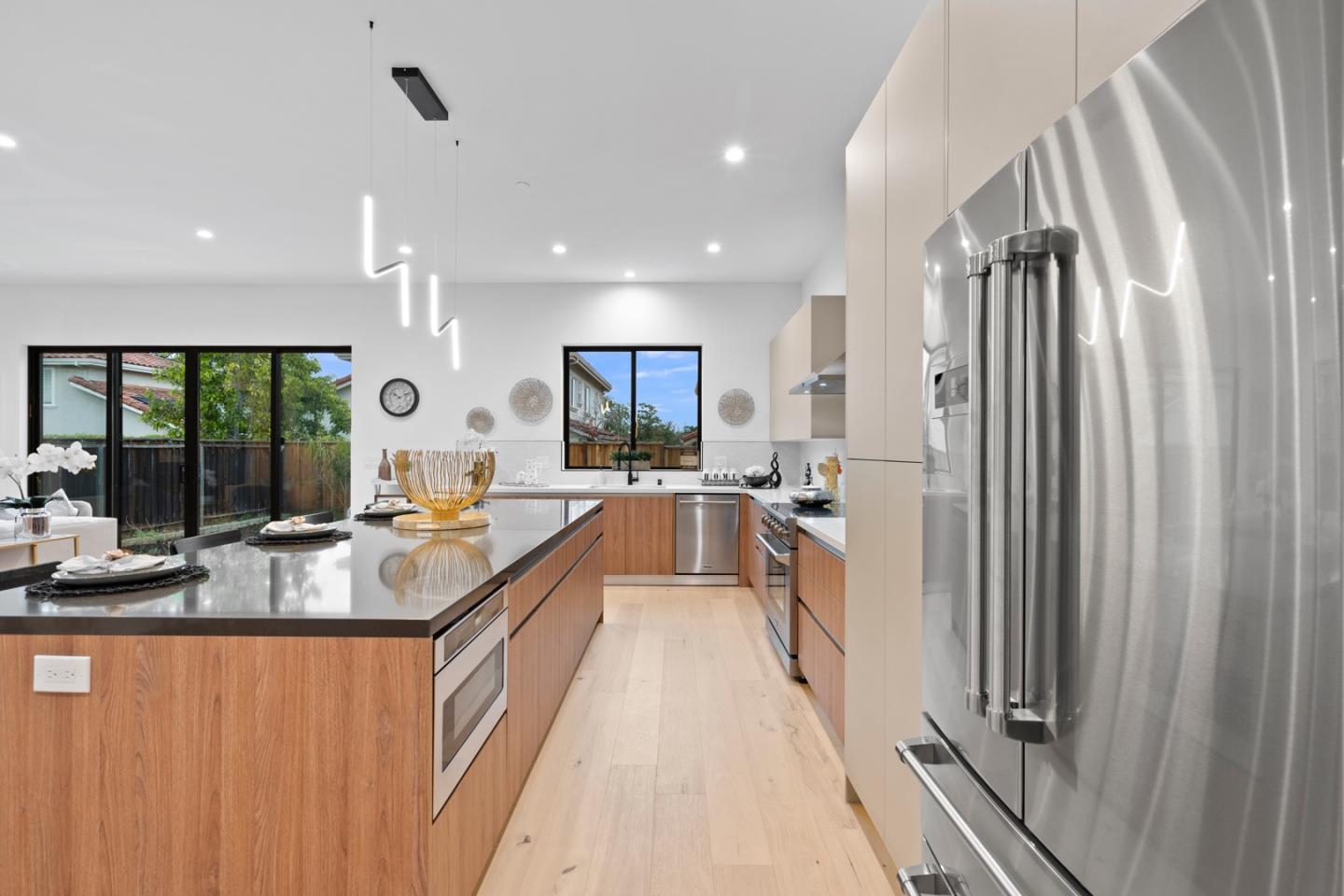 719 East Homestead Road Sunnyvale, CA 94087 - Photo 17 of 47 a large kitchen with stainless steel appliances a large counter top a stove a chimney a sink and a large window