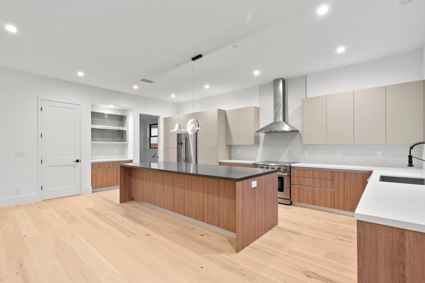 719 East Homestead Road Sunnyvale, CA 94087 - Photo 40 of 47 a large kitchen with stainless steel appliances kitchen island granite countertop a large counter top and wooden floors