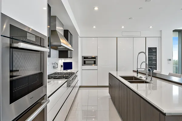 a kitchen with stainless steel appliances kitchen island granite countertop a stove and a refrigerator