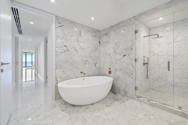 a view of a bathroom with a tub shower and sink
