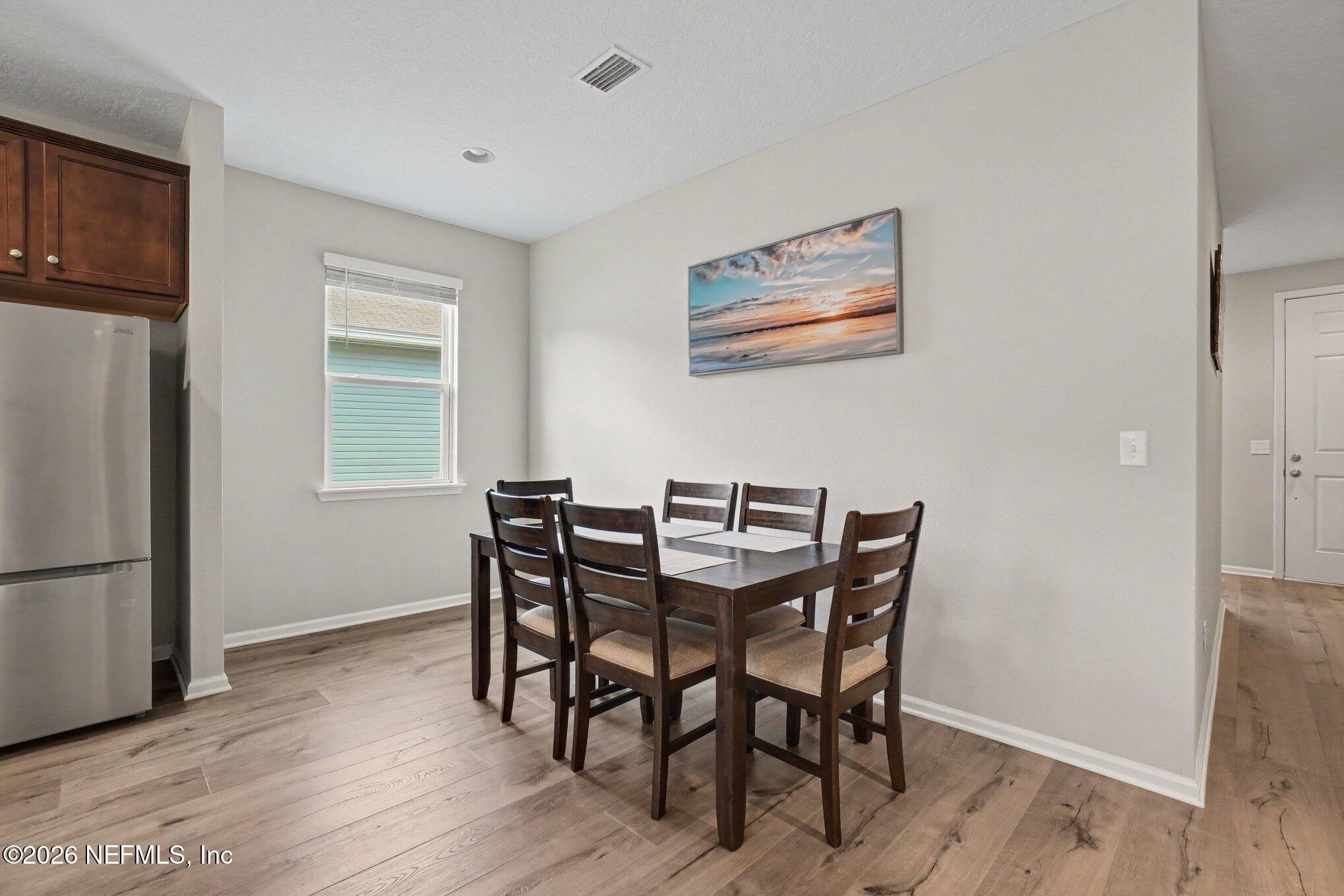 4630 Pine Ridge Parkway Middleburg, FL 32068 - Photo 8 of 35 a view of a dining room with furniture and a window