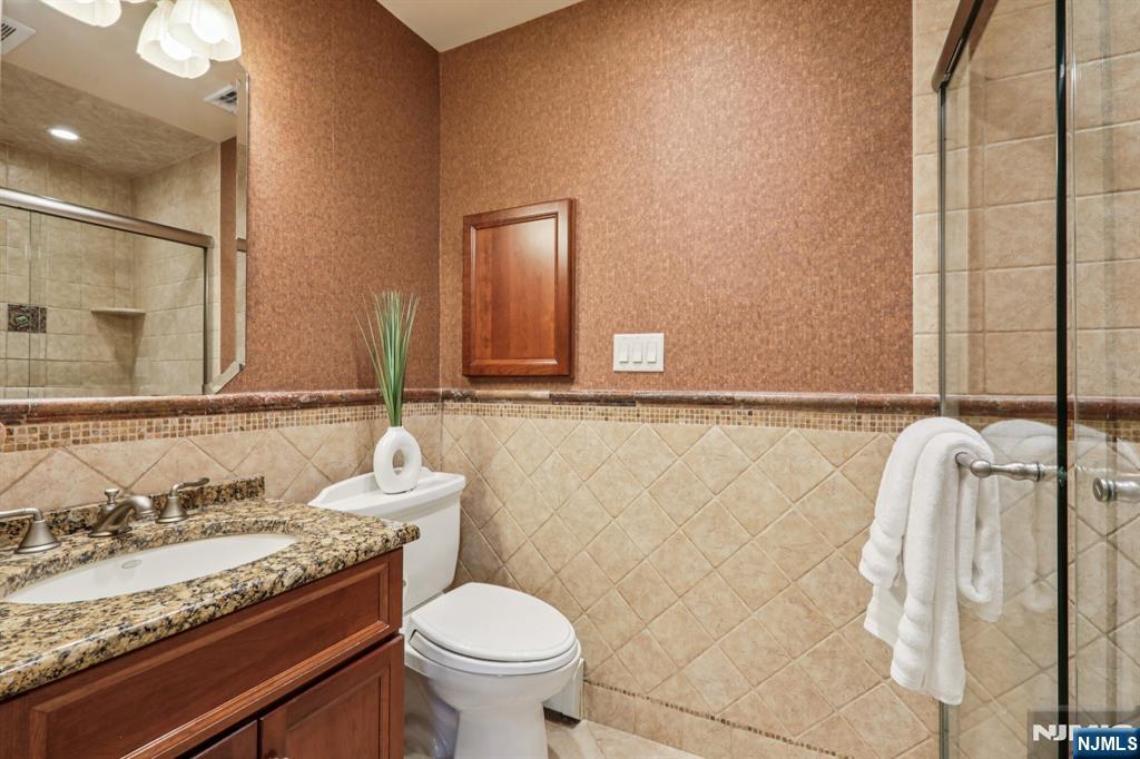 132 Dimmig Road Upper Saddle River, NJ 07458 - Photo 18 of 33 a bathroom with a granite countertop sink and a mirror