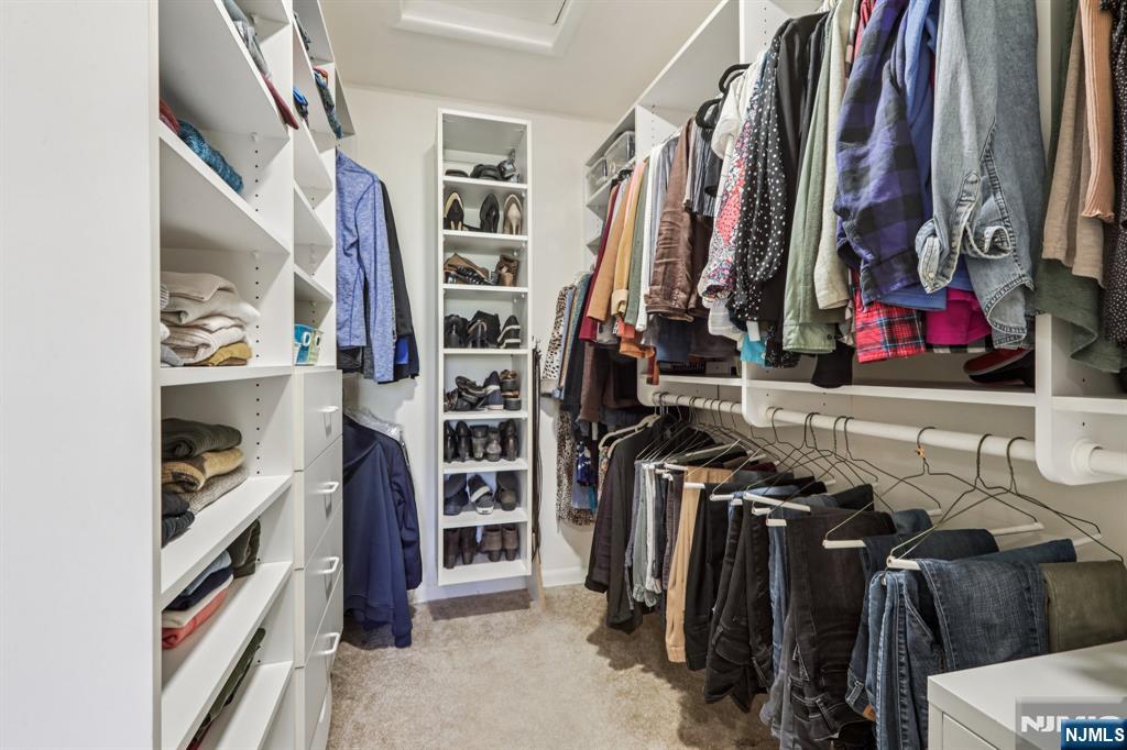 132 Dimmig Road Upper Saddle River, NJ 07458 - Photo 19 of 33 a view of walk in closet with clothes and shoes