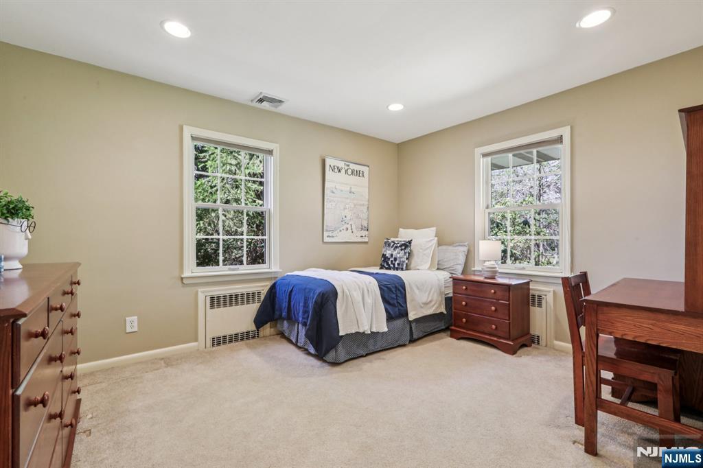 132 Dimmig Road Upper Saddle River, NJ 07458 - Photo 20 of 33 a spacious bedroom with a bed and a window