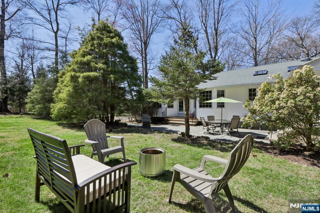 132 Dimmig Road Upper Saddle River, NJ 07458 - Photo 27 of 33 a view of a chairs and table in backyard of the house