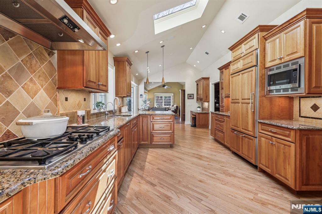 132 Dimmig Road Upper Saddle River, NJ 07458 - Photo 8 of 33 a kitchen with stainless steel appliances granite countertop a stove and a refrigerator