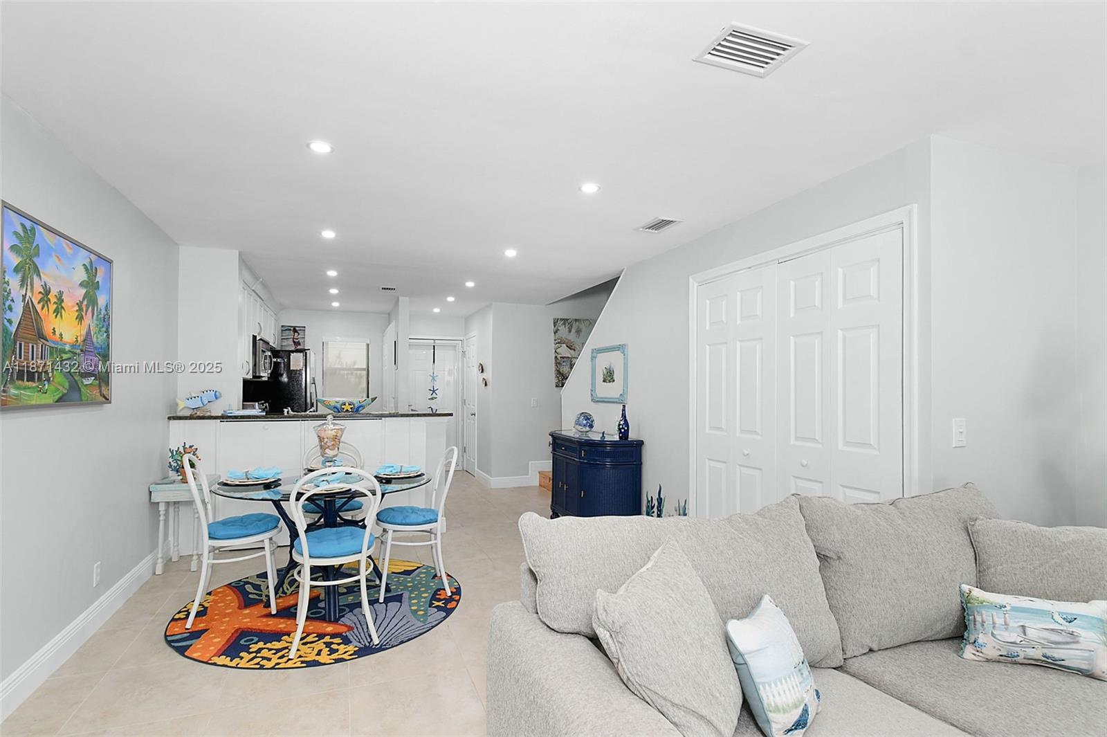 9421 South Ocean Drive, Unit 90 Jensen Beach, FL 34957 - Photo 15 of 49 a living room with furniture and a flat screen tv