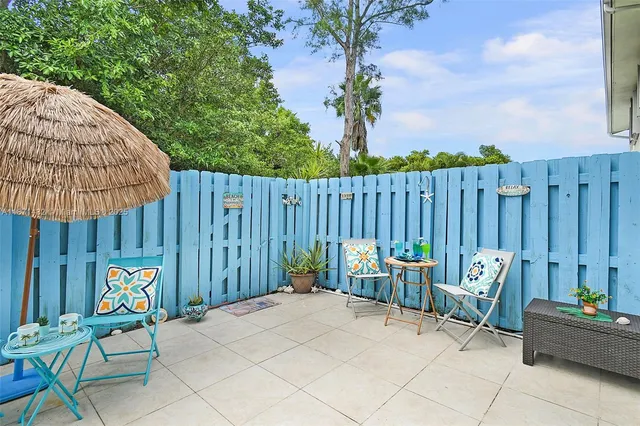 a view of outdoor sitting area with furniture and wooden fence