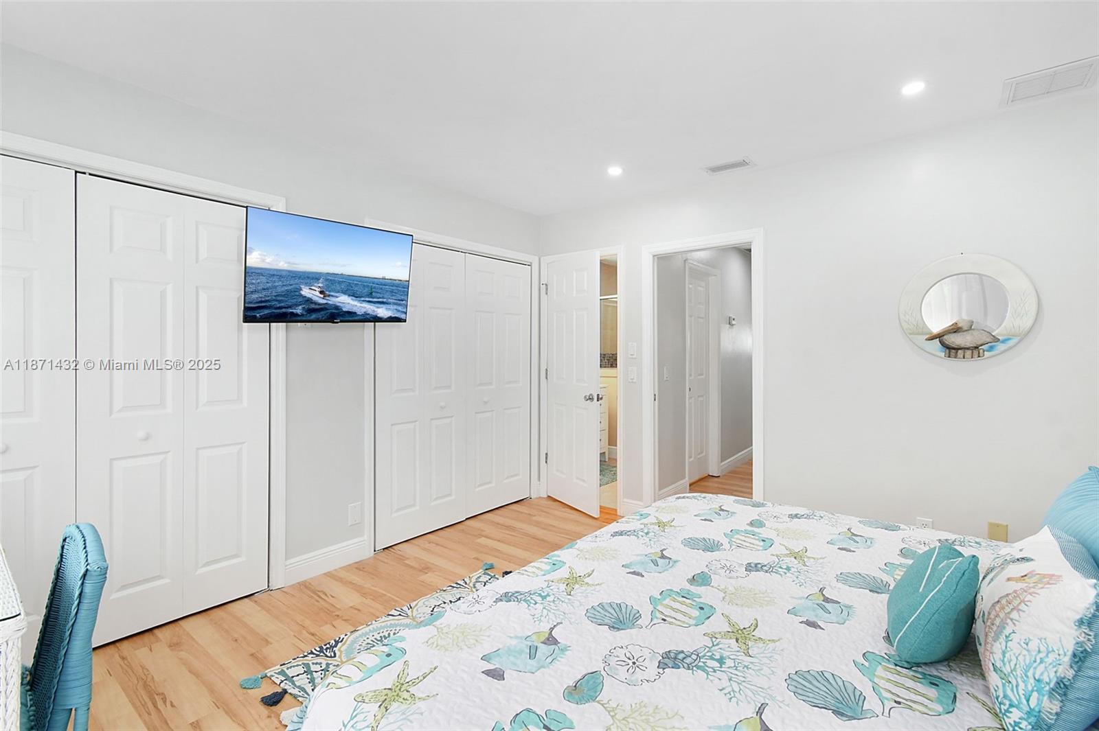 9421 South Ocean Drive, Unit 90 Jensen Beach, FL 34957 - Photo 23 of 49 a bedroom with a bed and a window