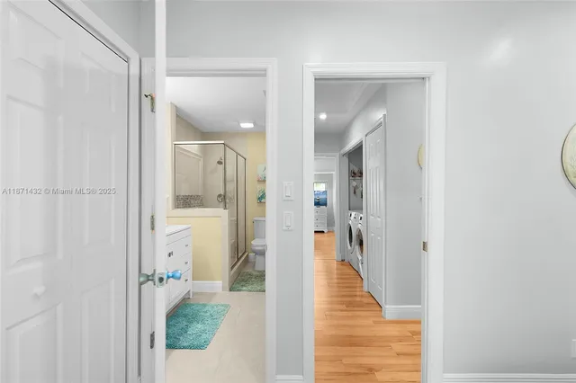 a bathroom with a sink a toilet and a large mirror