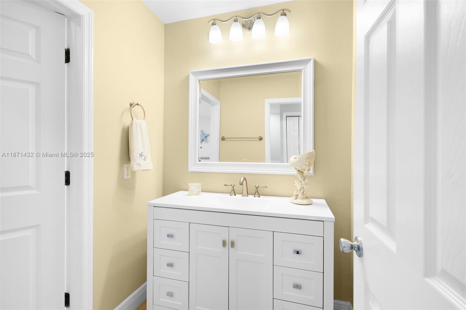 9421 South Ocean Drive, Unit 90 Jensen Beach, FL 34957 - Photo 26 of 49 a bathroom with a sink vanity and a mirror