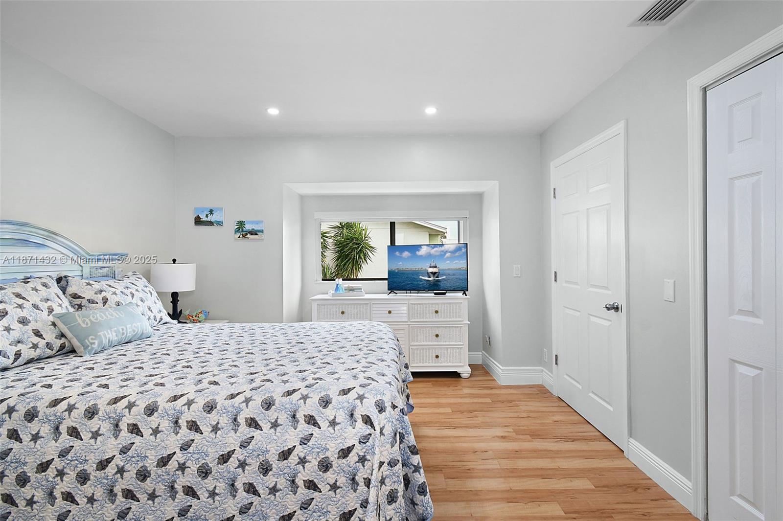 9421 South Ocean Drive, Unit 90 Jensen Beach, FL 34957 - Photo 30 of 49 a bedroom with a large bed and a dresser