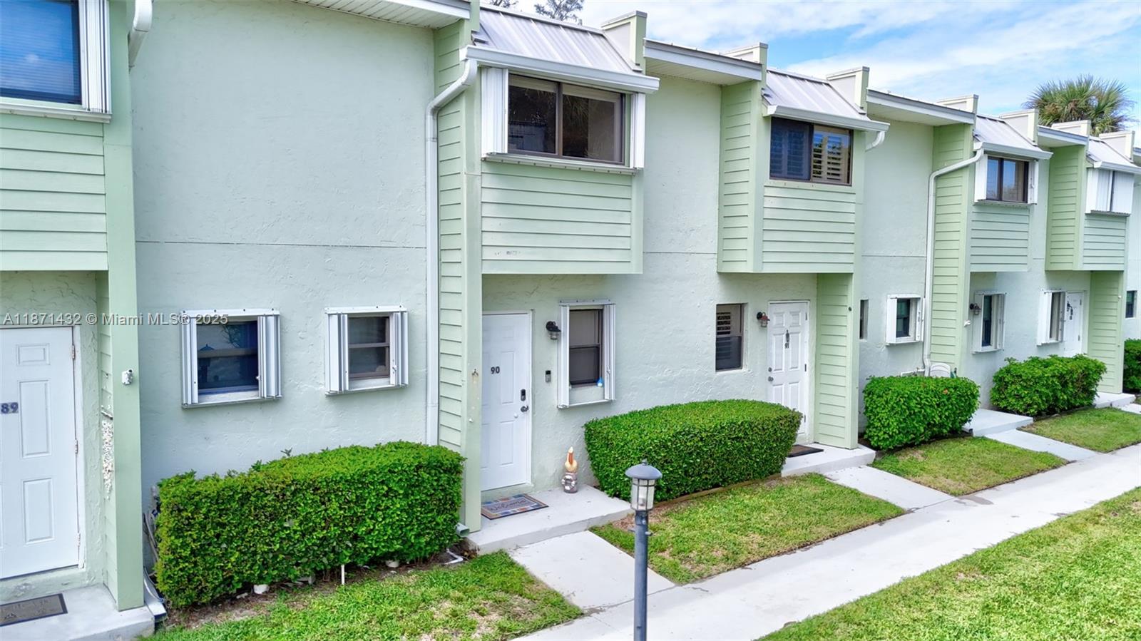 9421 South Ocean Drive, Unit 90 Jensen Beach, FL 34957 - Photo 34 of 49 a front view of a house with garden