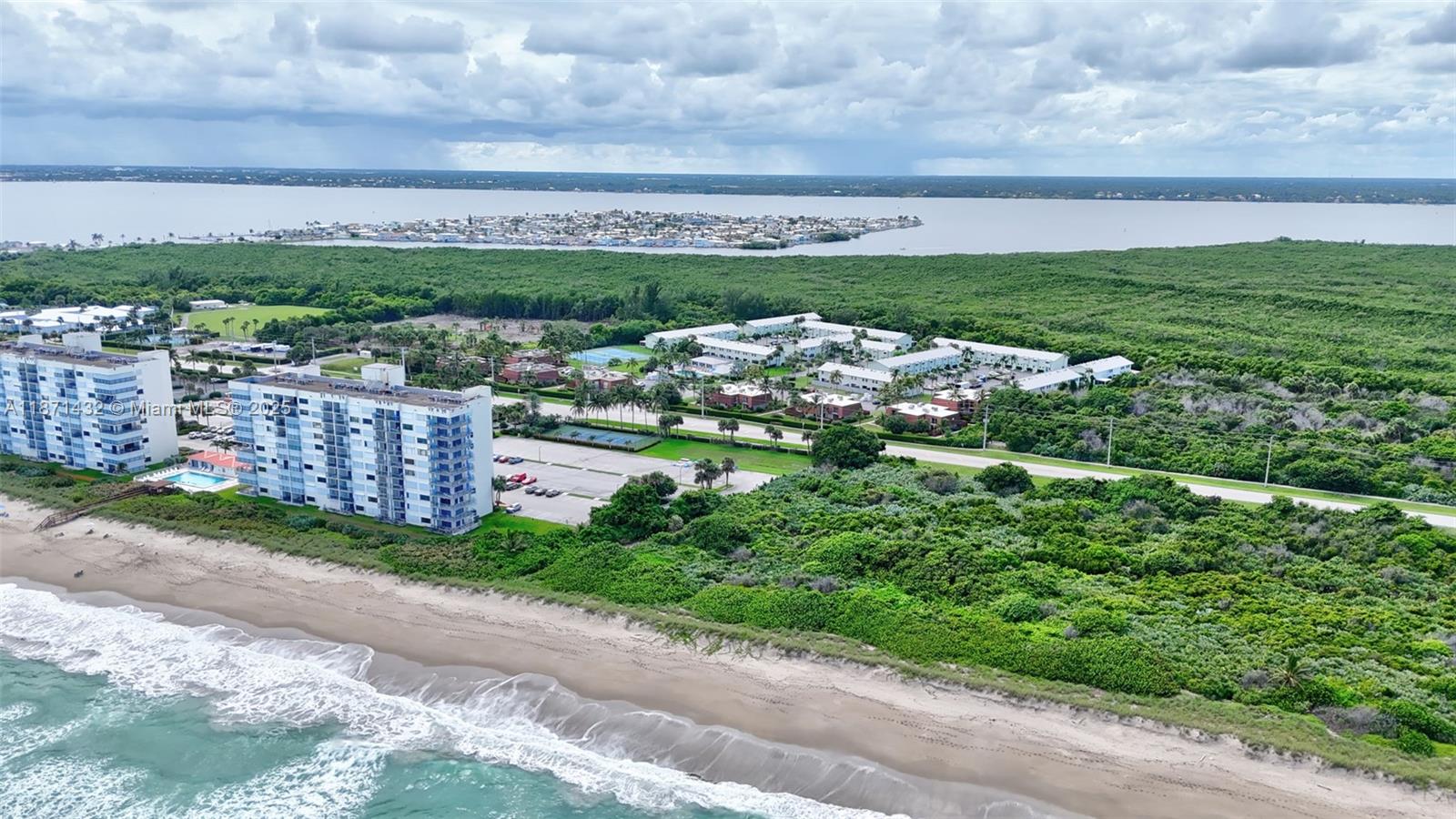 9421 South Ocean Drive, Unit 90 Jensen Beach, FL 34957 - Photo 36 of 49 a view of a city street both side of grassy field with shrub