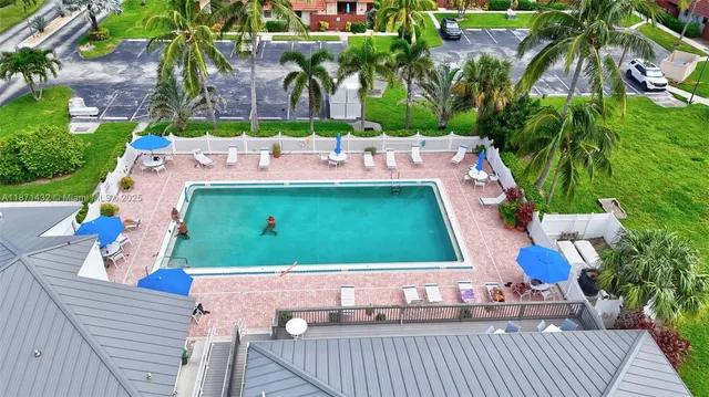 a view of swimming pool with a garden and plants