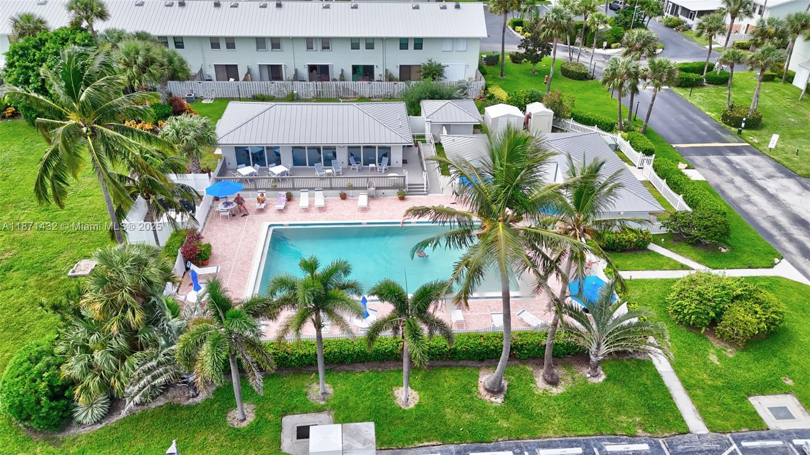 9421 South Ocean Drive, Unit 90 Jensen Beach, FL 34957 - Photo 40 of 49 a view of swimming pool with a garden and plants