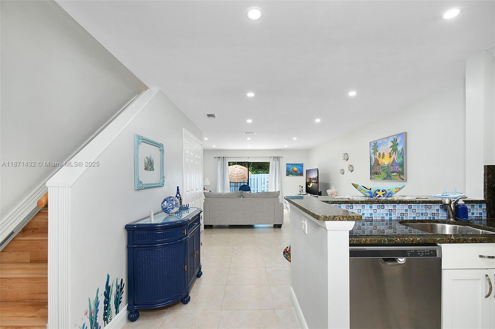 9421 South Ocean Drive, Unit 90 Jensen Beach, FL 34957 - Photo 4 of 49 a kitchen with stainless steel appliances granite countertop a sink and a refrigerator
