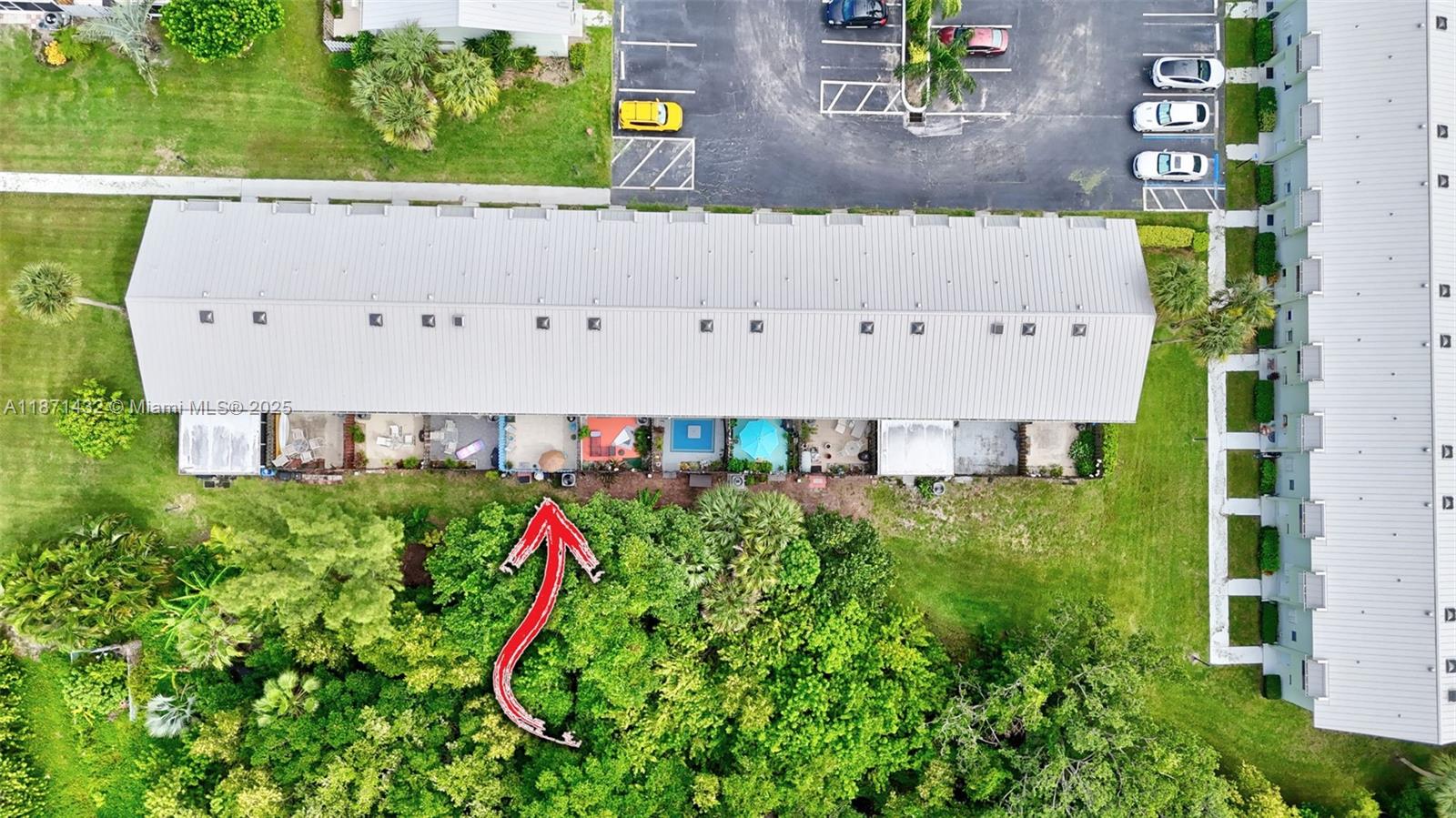 9421 South Ocean Drive, Unit 90 Jensen Beach, FL 34957 - Photo 46 of 49 an aerial view of a house with a yard and large trees