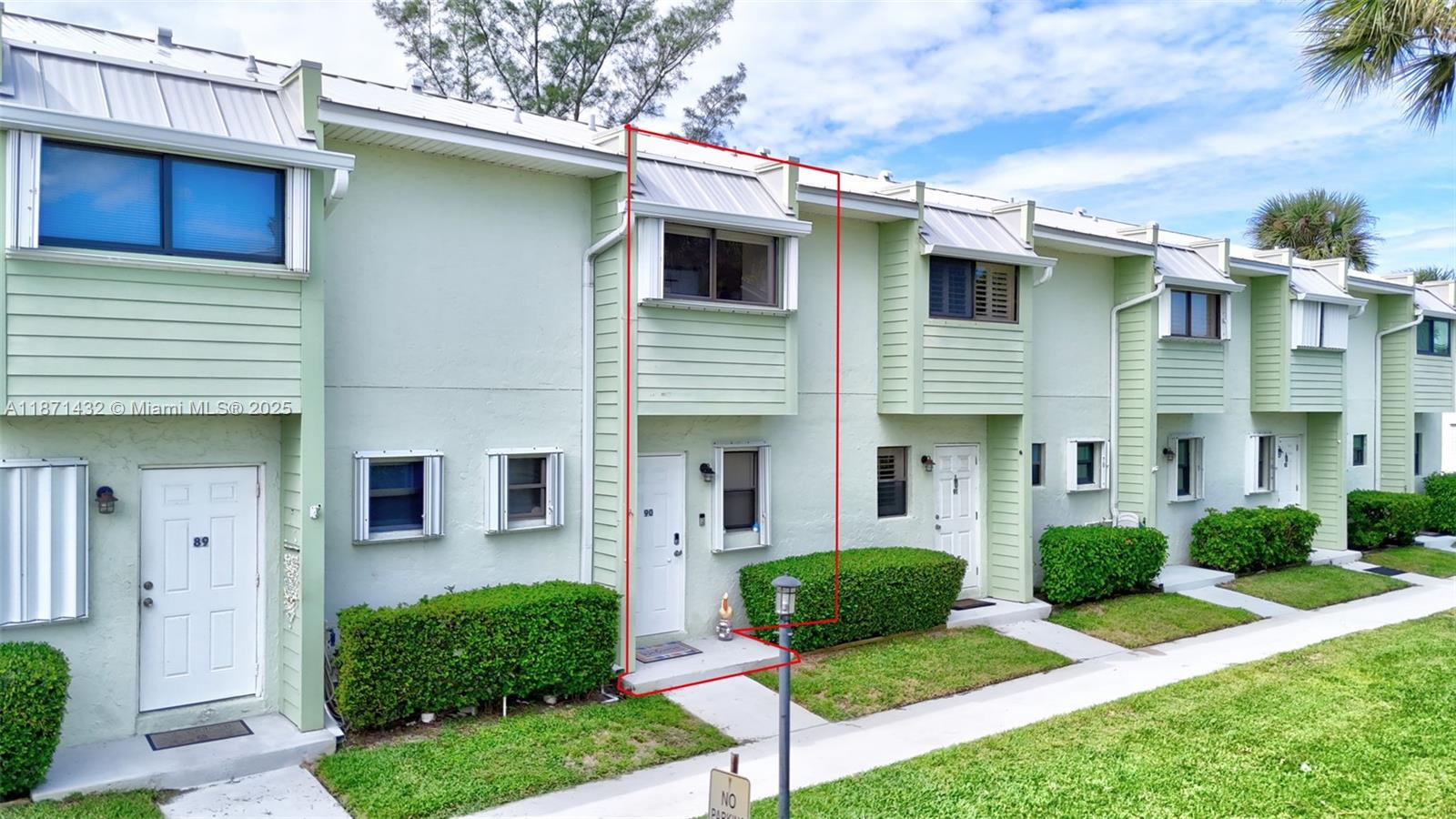 9421 South Ocean Drive, Unit 90 Jensen Beach, FL 34957 - Photo 48 of 49 a view of a white house next to a yard