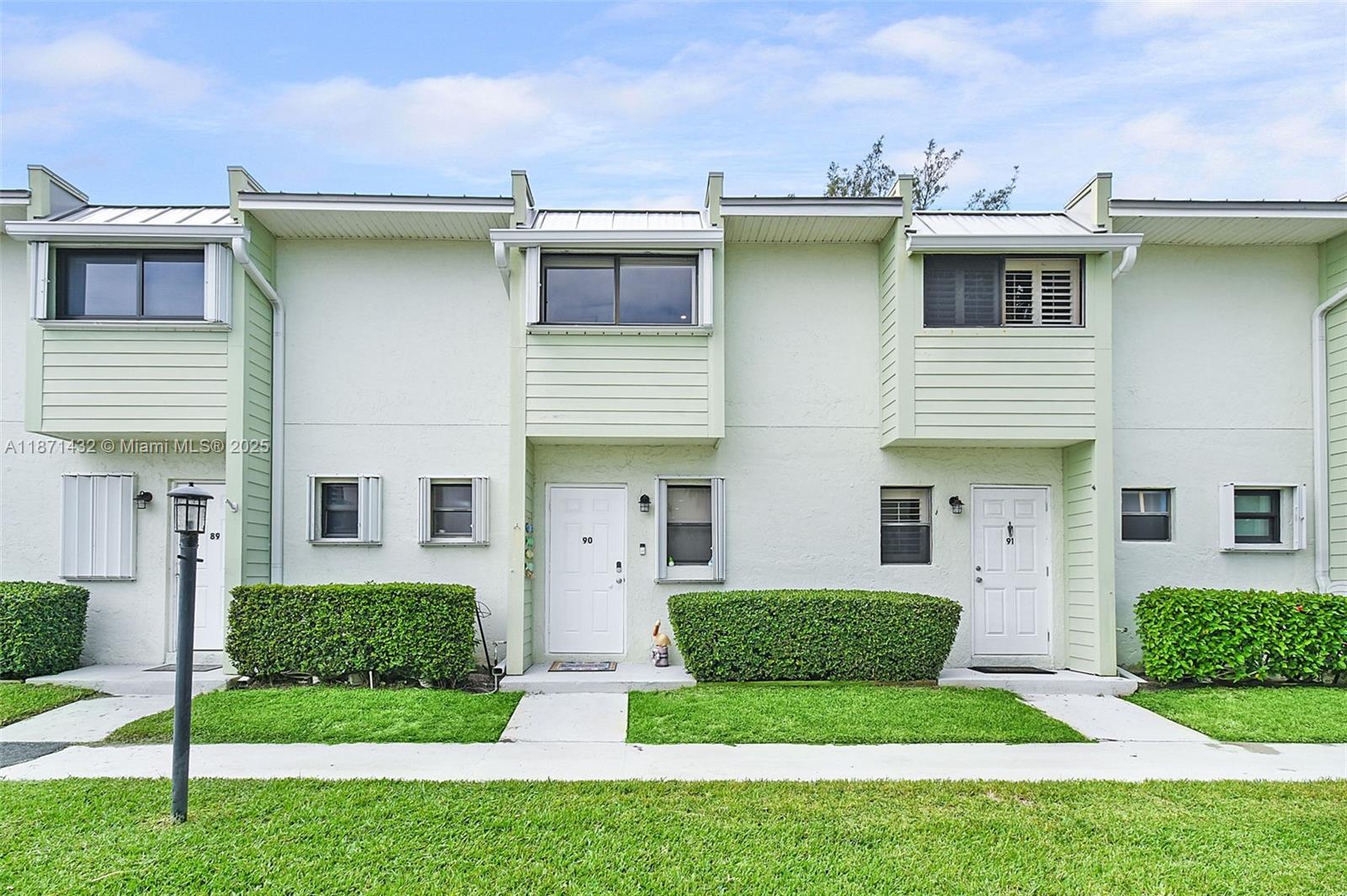 9421 South Ocean Drive, Unit 90 Jensen Beach, FL 34957 - Photo 49 of 49 a front view of a house with a yard