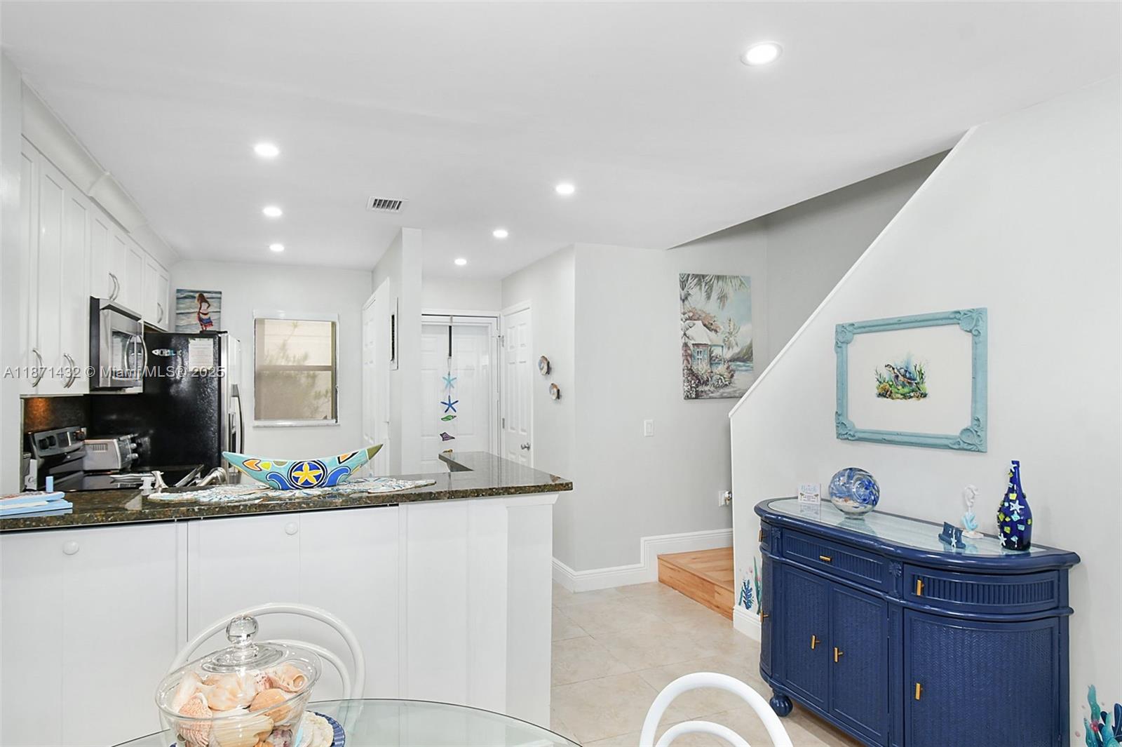 9421 South Ocean Drive, Unit 90 Jensen Beach, FL 34957 - Photo 6 of 49 a living room with furniture and a flat screen tv