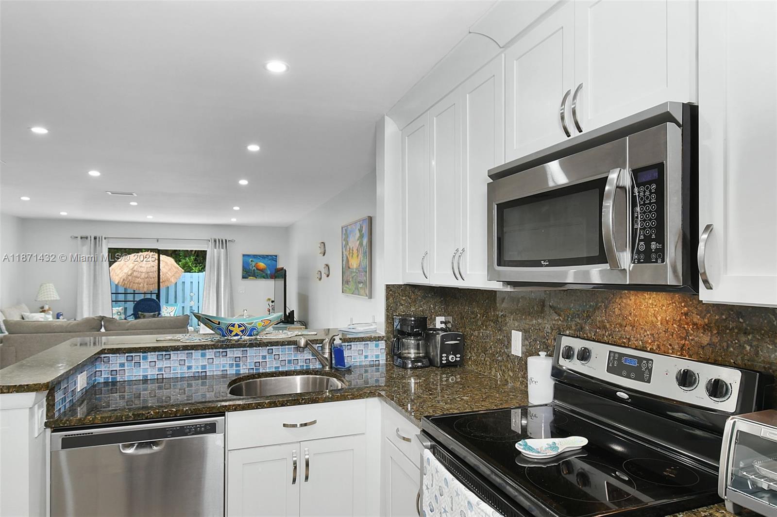 9421 South Ocean Drive, Unit 90 Jensen Beach, FL 34957 - Photo 8 of 49 a kitchen with a sink stove and microwave