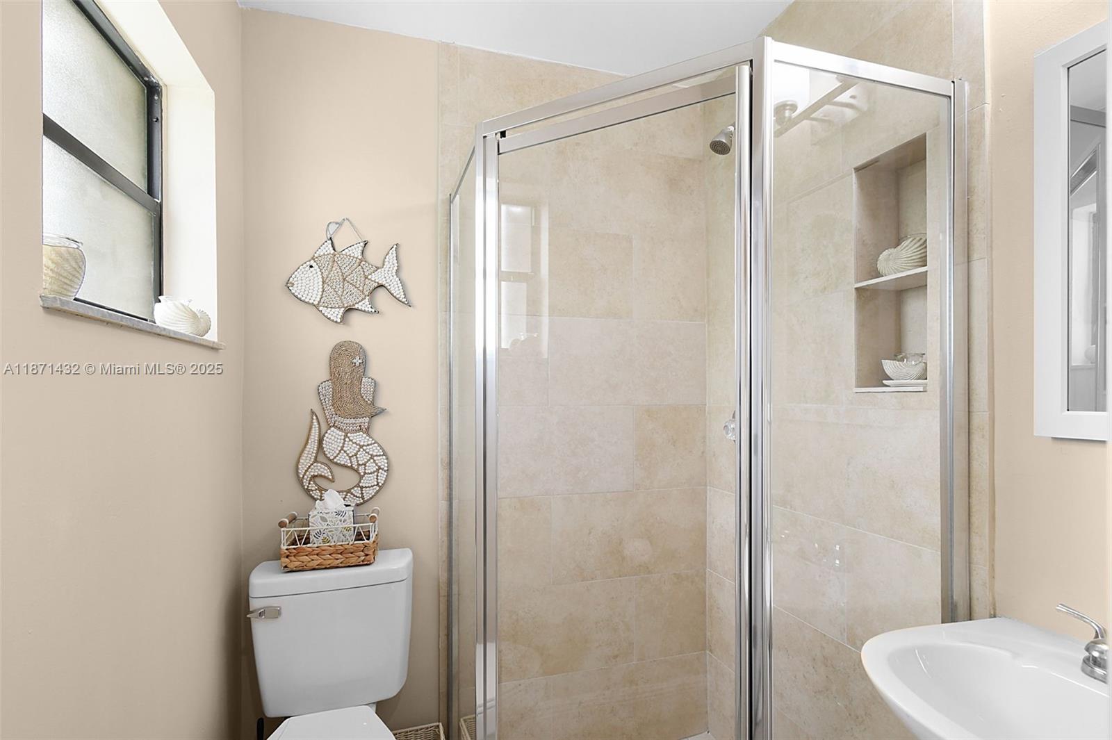 9421 South Ocean Drive, Unit 90 Jensen Beach, FL 34957 - Photo 9 of 49 a bathroom with a toilet sink and shower