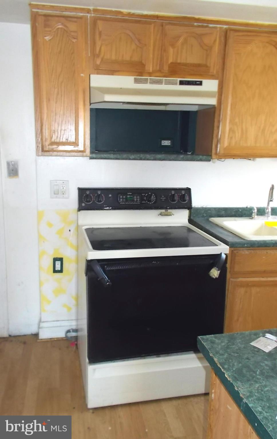 12823 Matey Road Silver Spring, MD 20906 - Photo 6 of 14 a stove top oven sitting inside of a kitchen