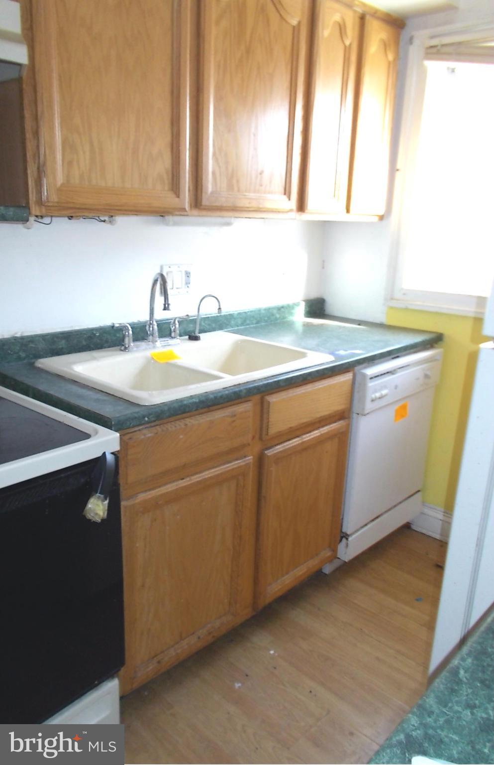 12823 Matey Road Silver Spring, MD 20906 - Photo 7 of 14 a kitchen with sink cabinets and window