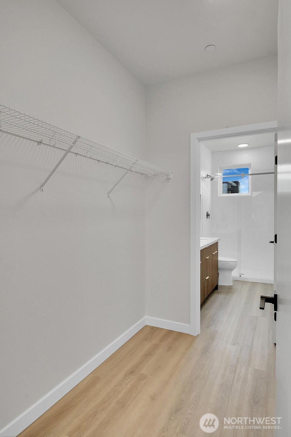 261 East Louisa Street Seattle, WA 98102 - Photo 14 of 24 a view of an empty room and a kitchen