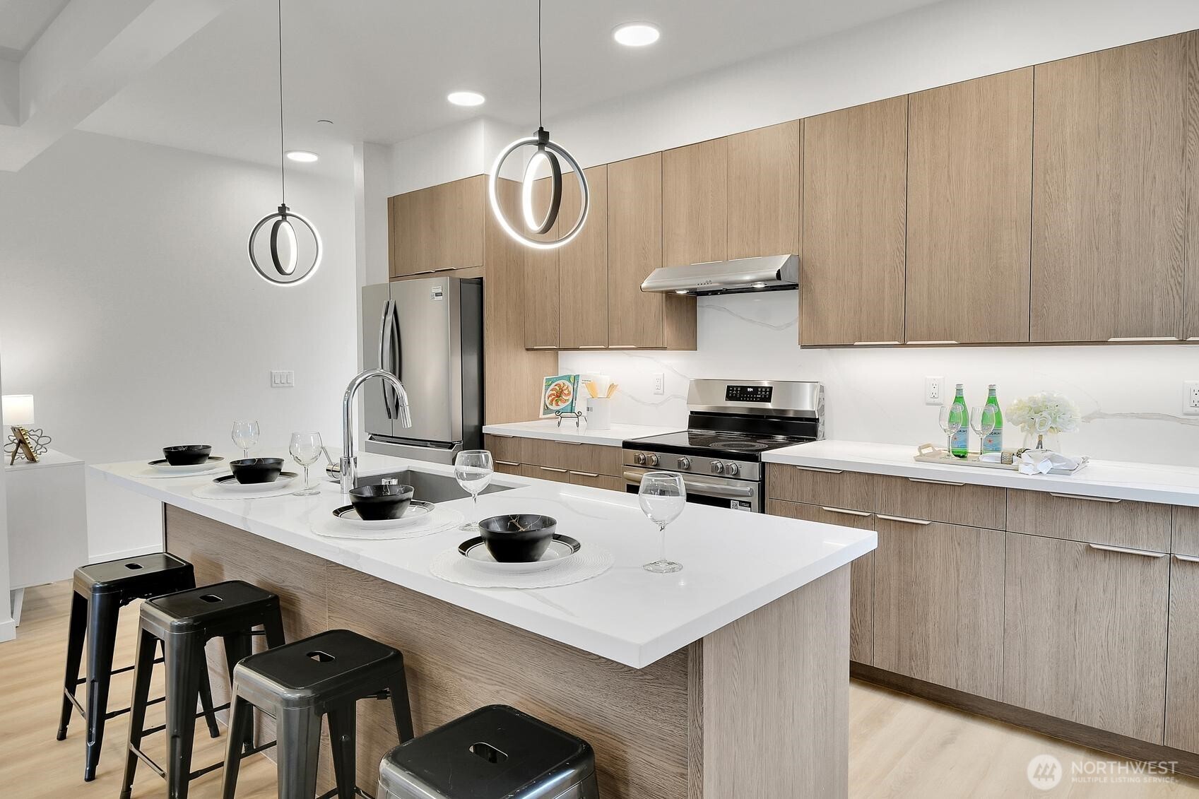261 East Louisa Street Seattle, WA 98102 - Photo 4 of 24 a kitchen with a sink a stove and chairs