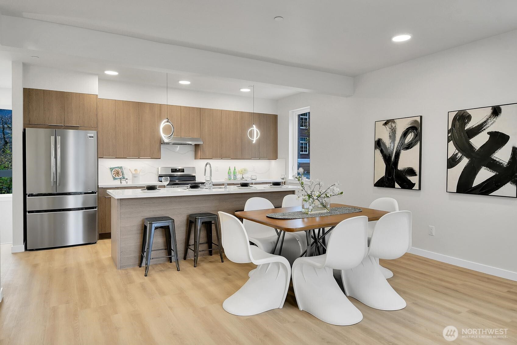 261 East Louisa Street Seattle, WA 98102 - Photo 5 of 24 a kitchen with granite countertop a white refrigerator oven a sink dishwasher and white cabinets with wooden floor