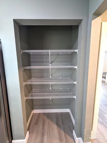 a view of walk in closet with empty racks