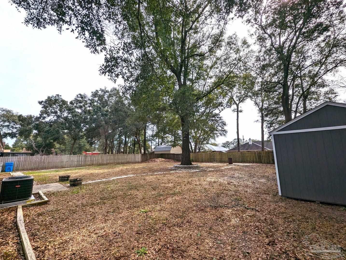 6045 Hamilton Bridge Road Milton, FL 32570 - Photo 28 of 31 a backyard of a house with lots of green space