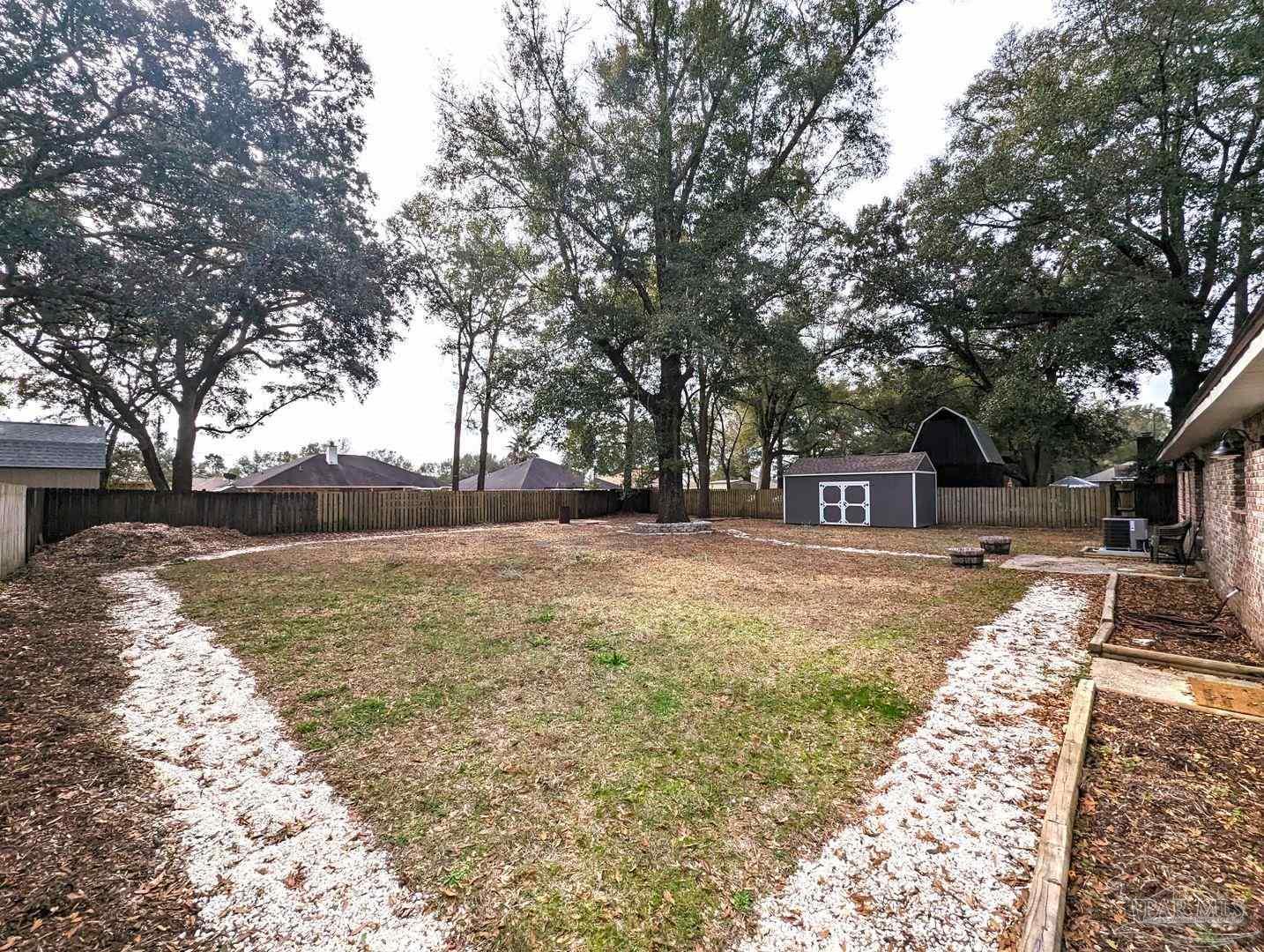 6045 Hamilton Bridge Road Milton, FL 32570 - Photo 29 of 31 a street view with large trees