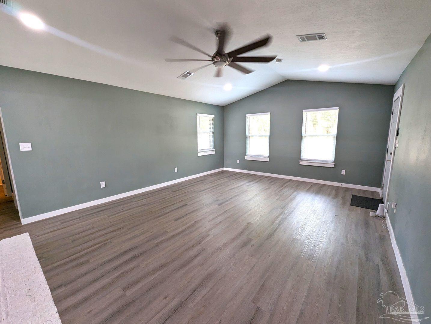 6045 Hamilton Bridge Road Milton, FL 32570 - Photo 3 of 31 wooden floor in an empty room with a window