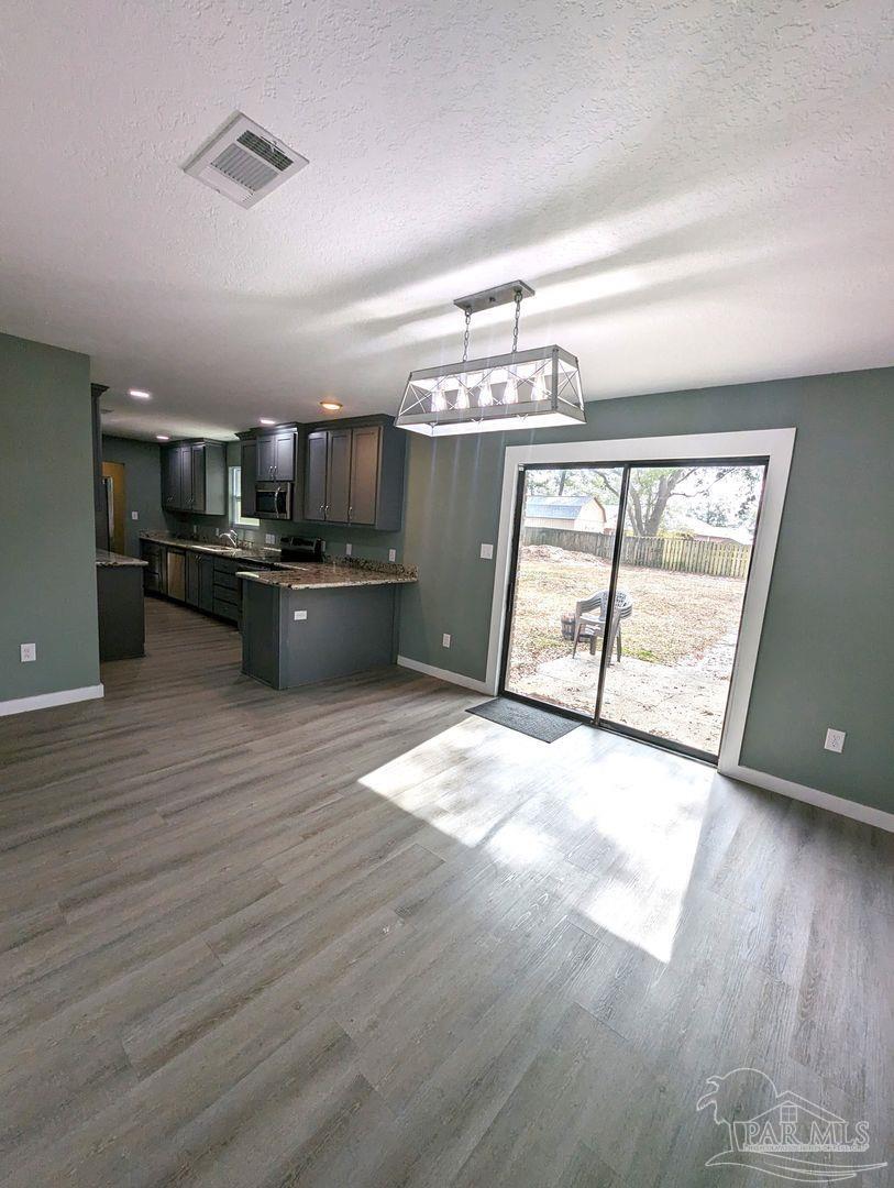 6045 Hamilton Bridge Road Milton, FL 32570 - Photo 6 of 31 a view of kitchen with granite countertop window and stainless steel appliances