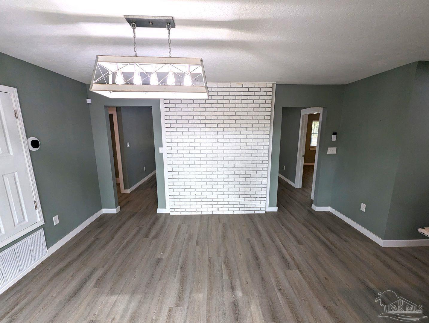 6045 Hamilton Bridge Road Milton, FL 32570 - Photo 8 of 31 a view of an empty room with wooden floor and a window