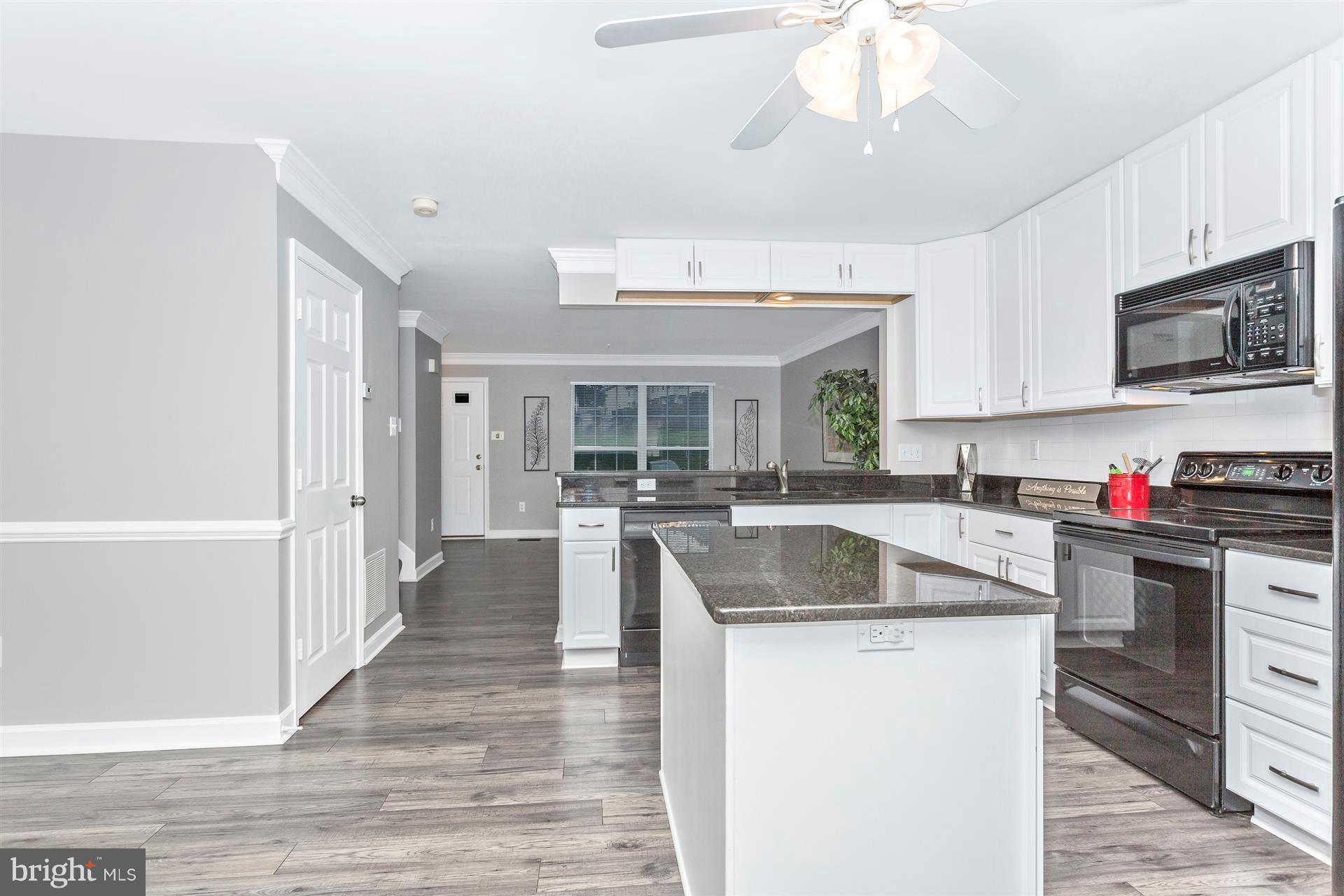 6408 View Point Court Frederick, MD 21703 - Photo 11 of 30 a kitchen with stainless steel appliances granite countertop a sink stove and refrigerator