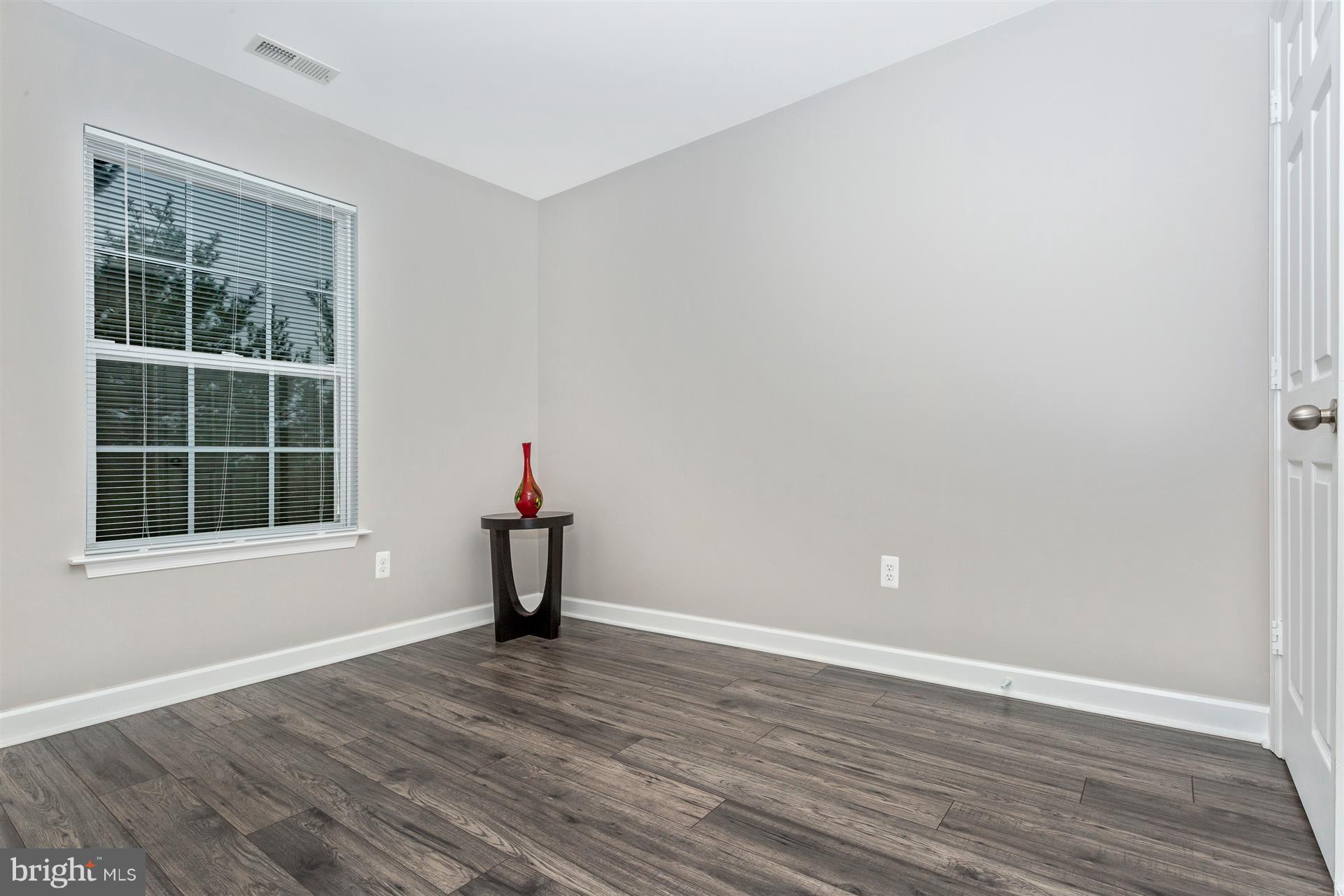 6408 View Point Court Frederick, MD 21703 - Photo 14 of 30 a view of empty room with wooden floor and fan