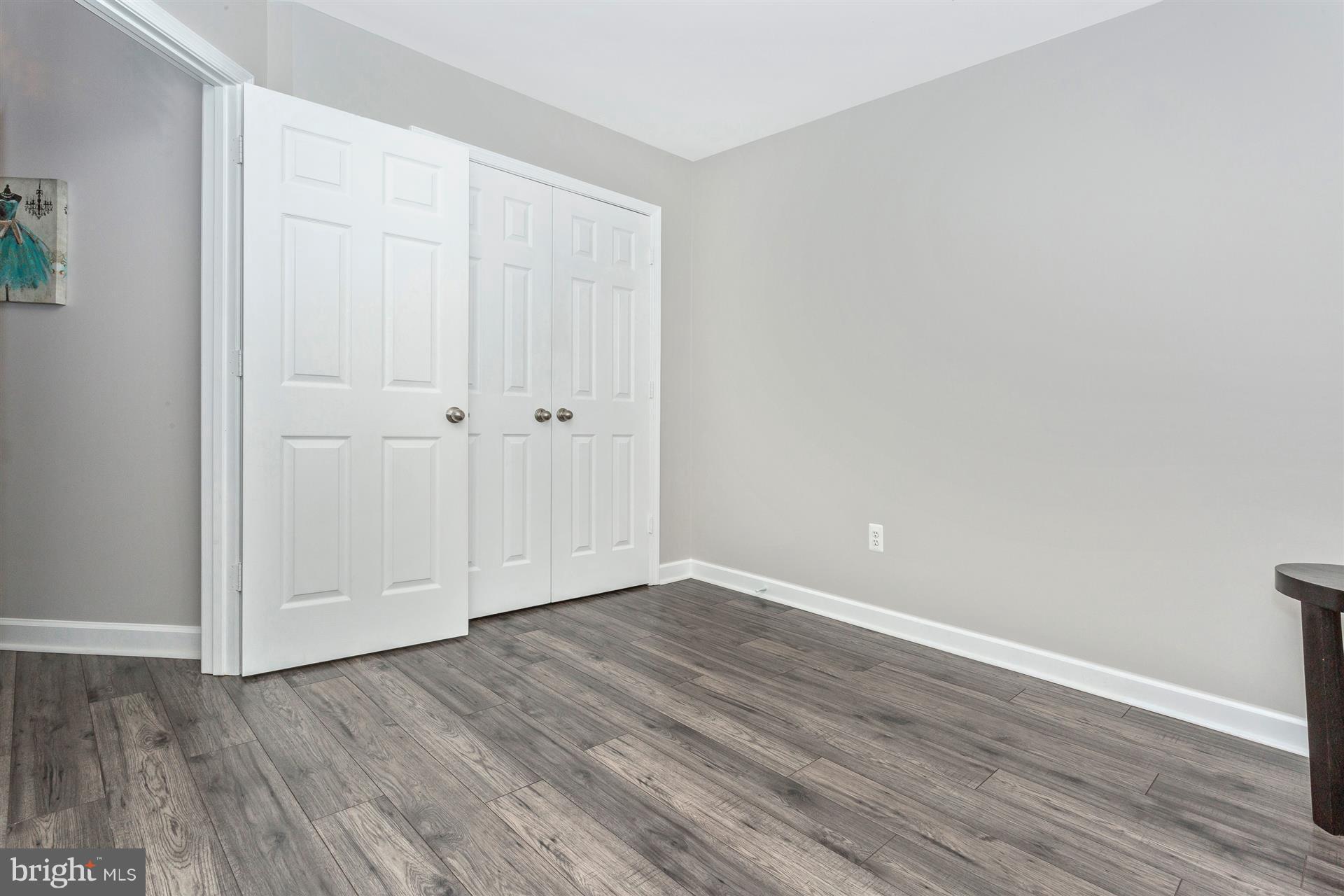 6408 View Point Court Frederick, MD 21703 - Photo 16 of 30 a view of an empty room with wooden floor