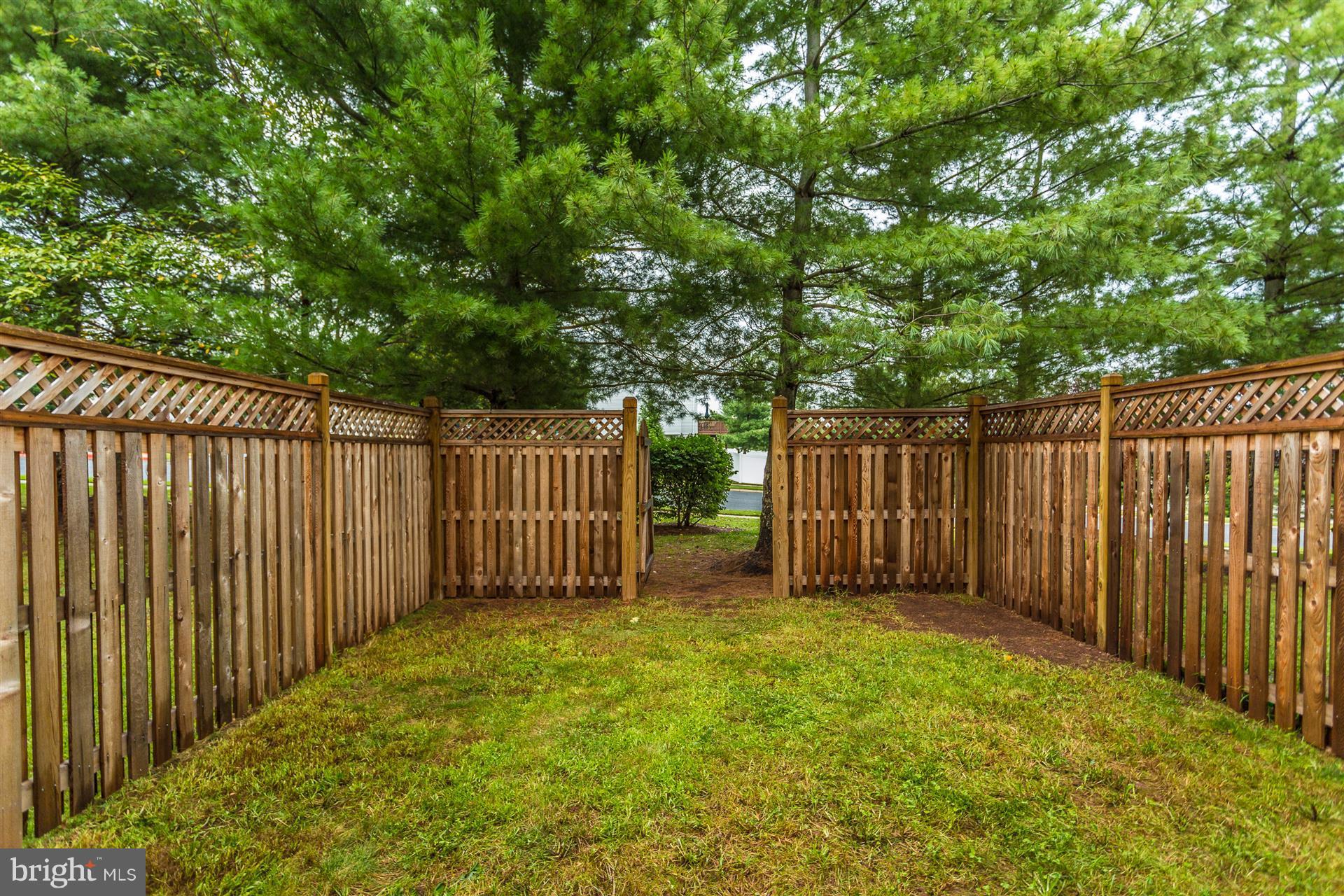 6408 View Point Court Frederick, MD 21703 - Photo 28 of 30 a view of backyard with wooden fence and large trees