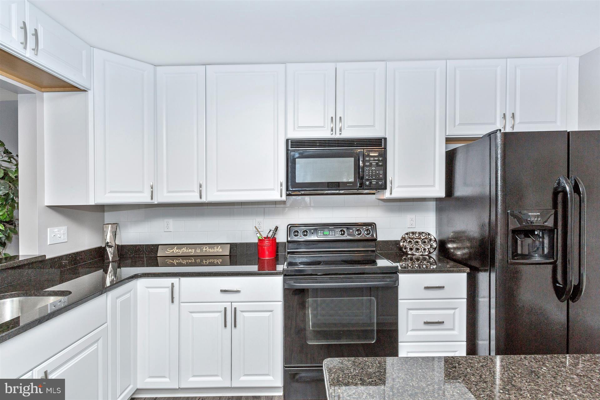 6408 View Point Court Frederick, MD 21703 - Photo 7 of 30 a kitchen with white cabinets and stainless steel appliances