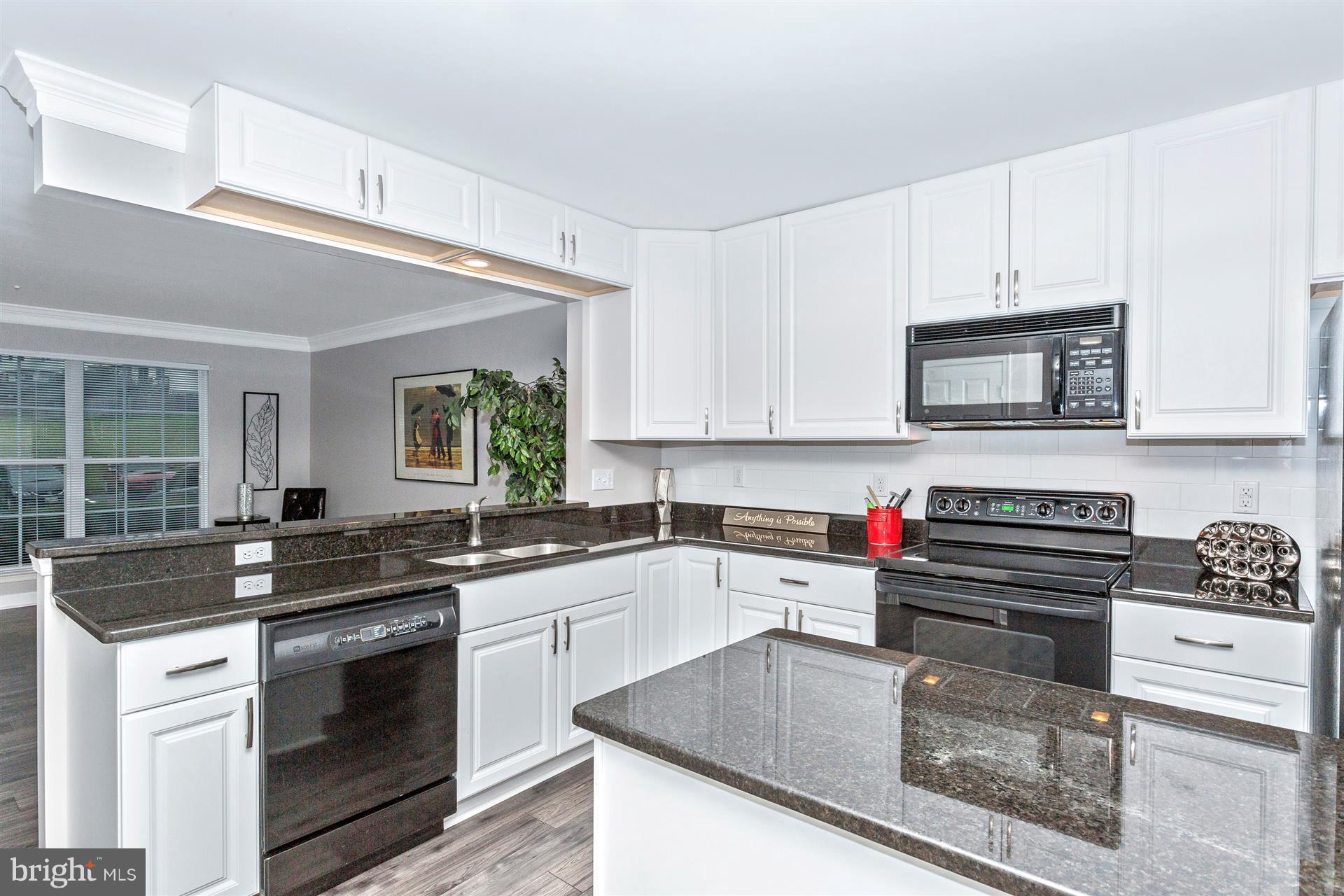6408 View Point Court Frederick, MD 21703 - Photo 8 of 30 a kitchen with granite countertop a sink a stove and cabinets