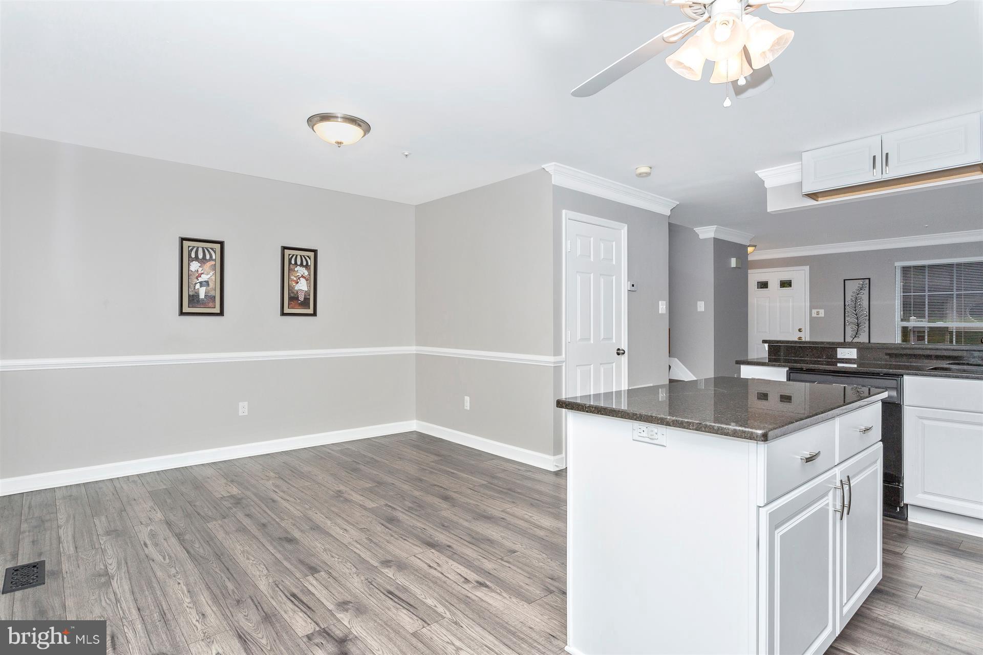6408 View Point Court Frederick, MD 21703 - Photo 10 of 30 a kitchen with granite countertop a sink cabinets and wooden floor